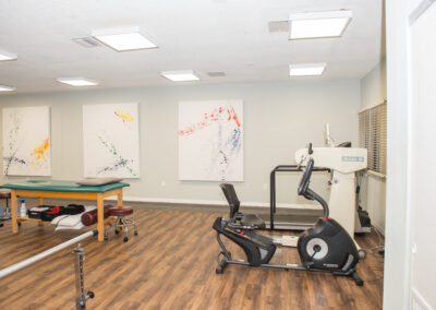 treatment table and cardio therapy area in physical therapy clinic