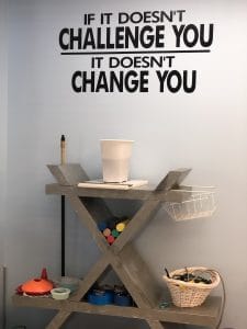 Physical Therapy clinic wall unit with therapy equipment and motivational quote on wall